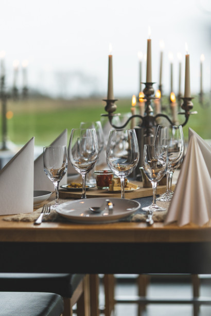Festively set table in the conservatory of the Element restaurant by candlelight.